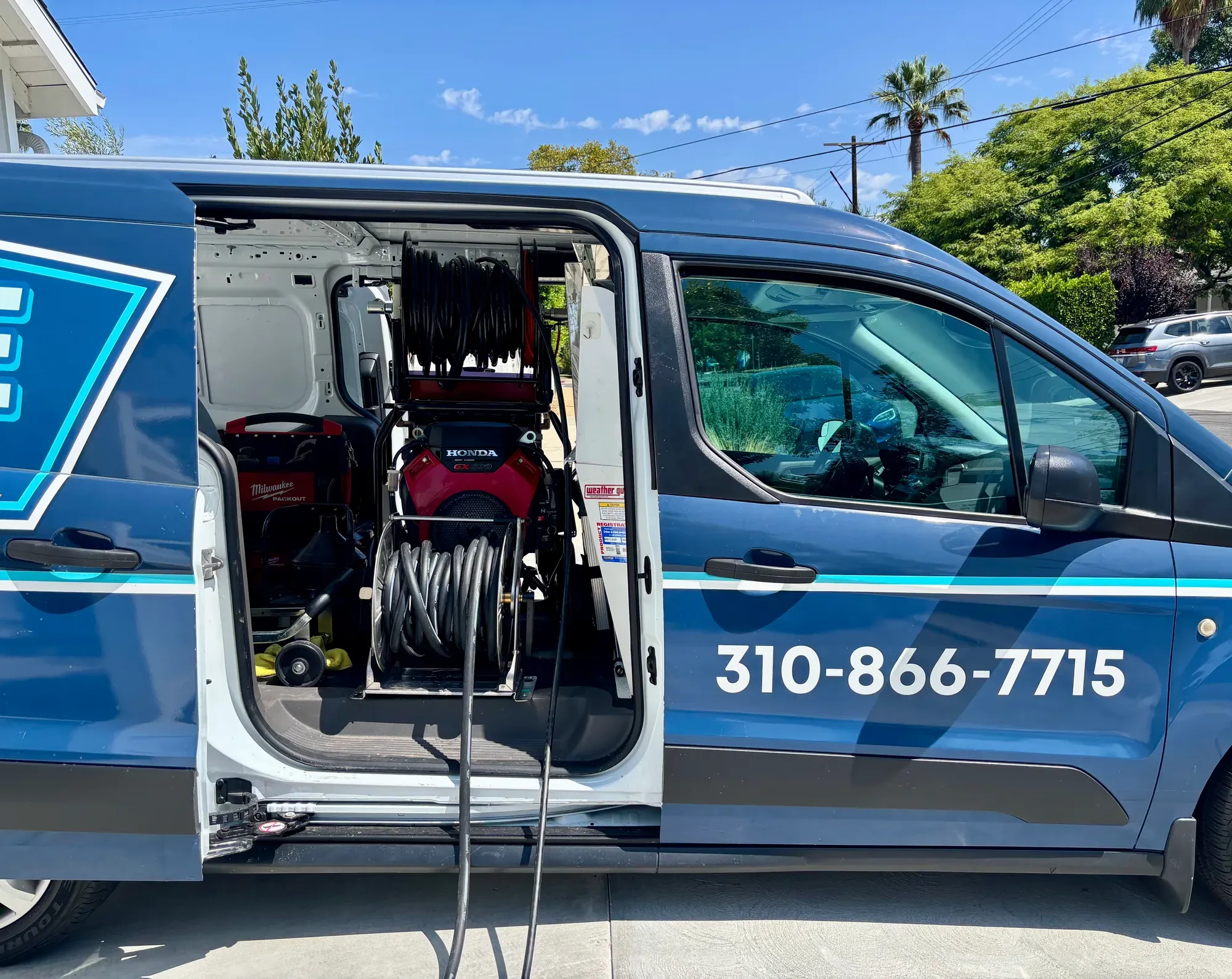 Hose reel mounted inside a Mr. Pipe service van
