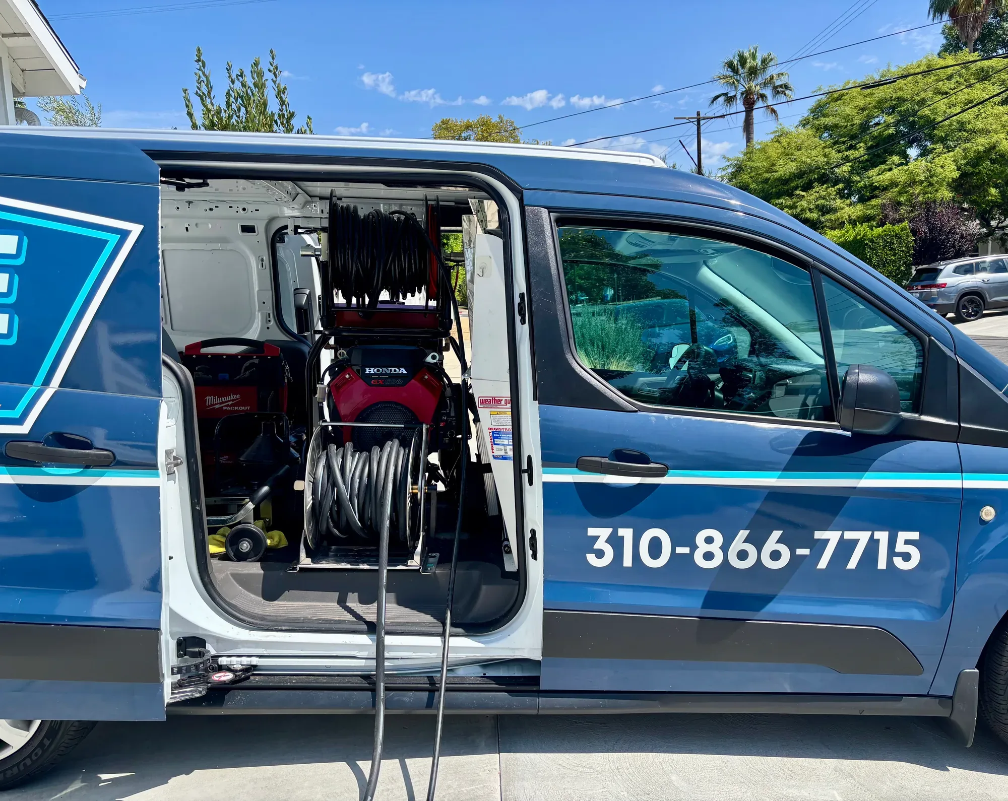 Hose reel mounted inside a Mr. Pipe service van
