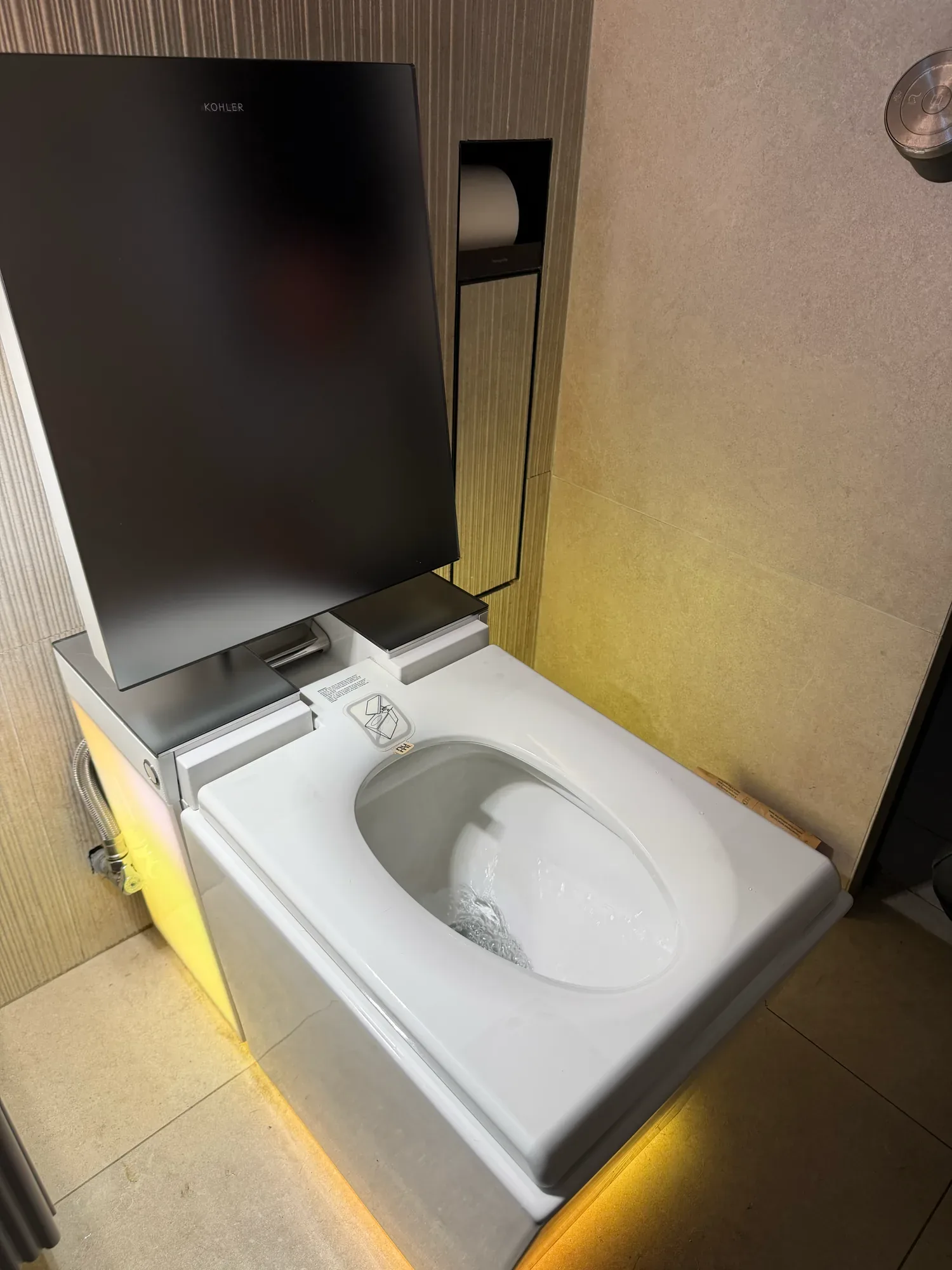 Kohler smart toilet with raised lid and integrated lighting