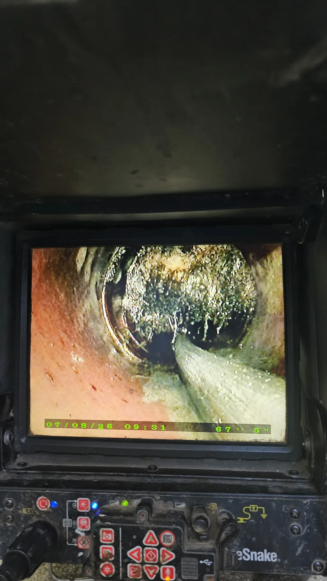 Sewer camera monitor showing the inside of a pipe